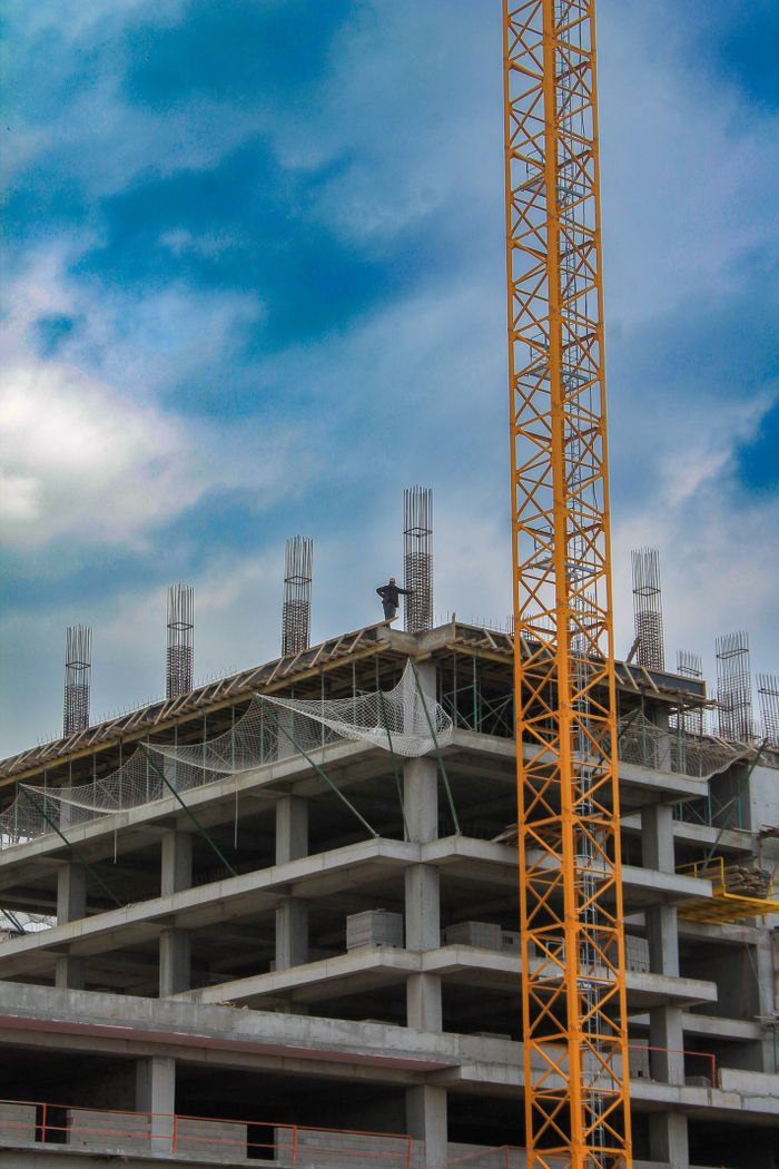 our-stories Construction site with crane and building in Bursa, Türkiye under clear sky.